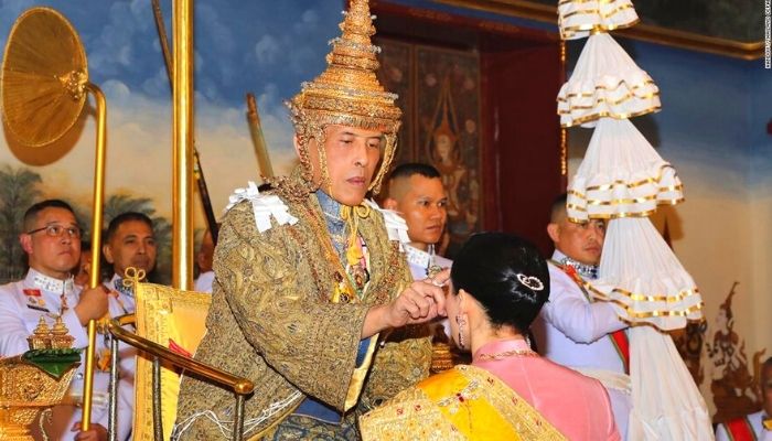 King coronation ceremonry - Thai king performing ritual at the coronation ceremony influenced by Indian customs & traditions